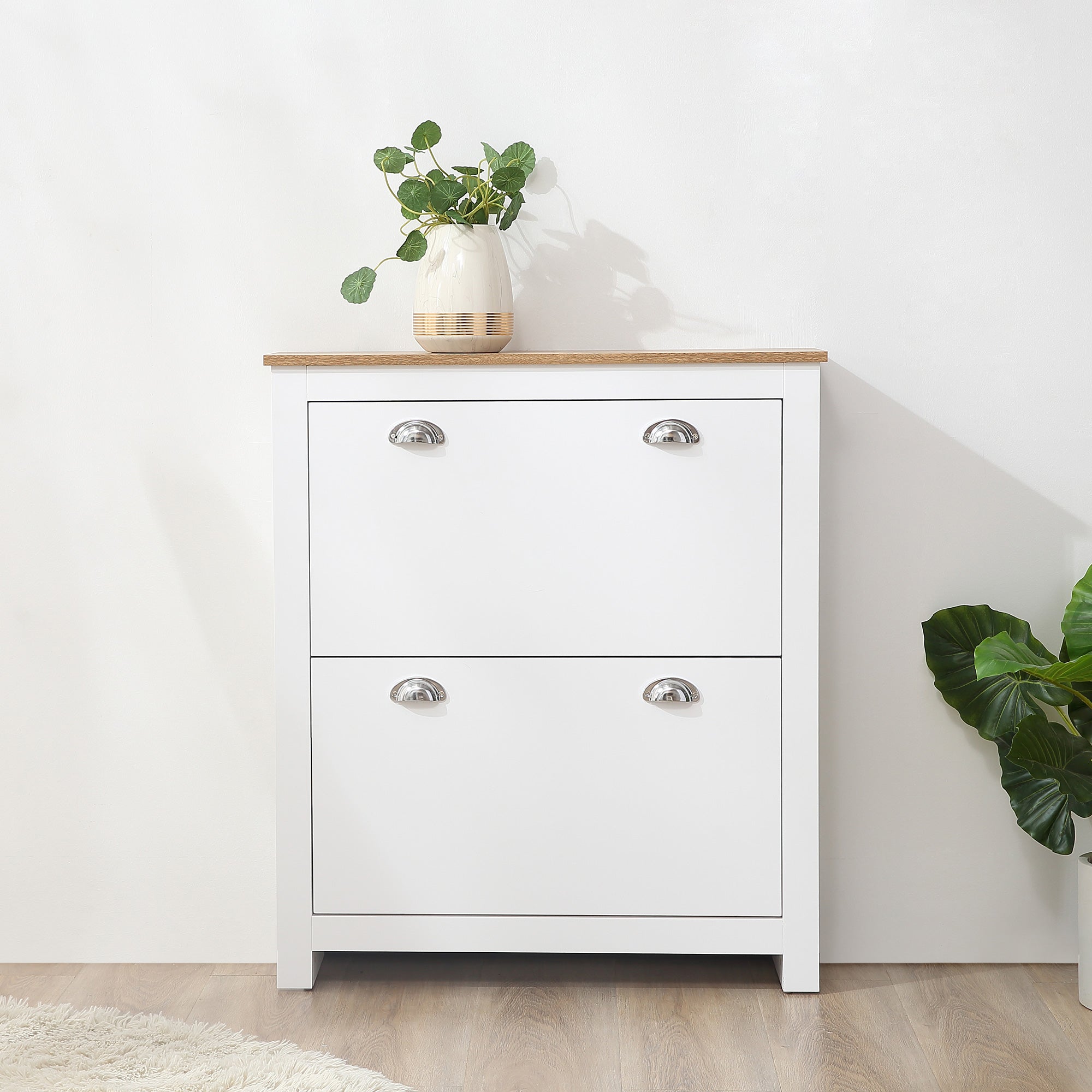 White two-drawer shoe cabinet with light wood top silver handles and adjustable shelf for hallway storage with two tipping drawers