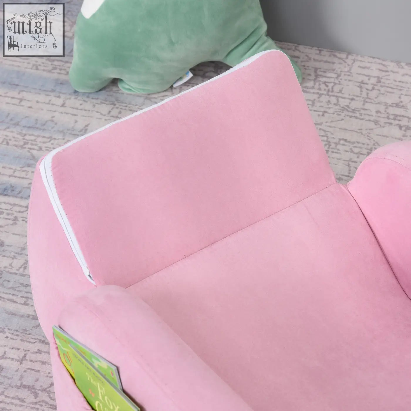 Pink homcom kids armchair with wood frame and white trim features a side pocket with a book, doubling as a sofa bed