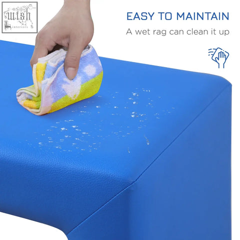 Blue toddler sofa chair with wooden frame and faux leather surface being wiped clean with colorful towel