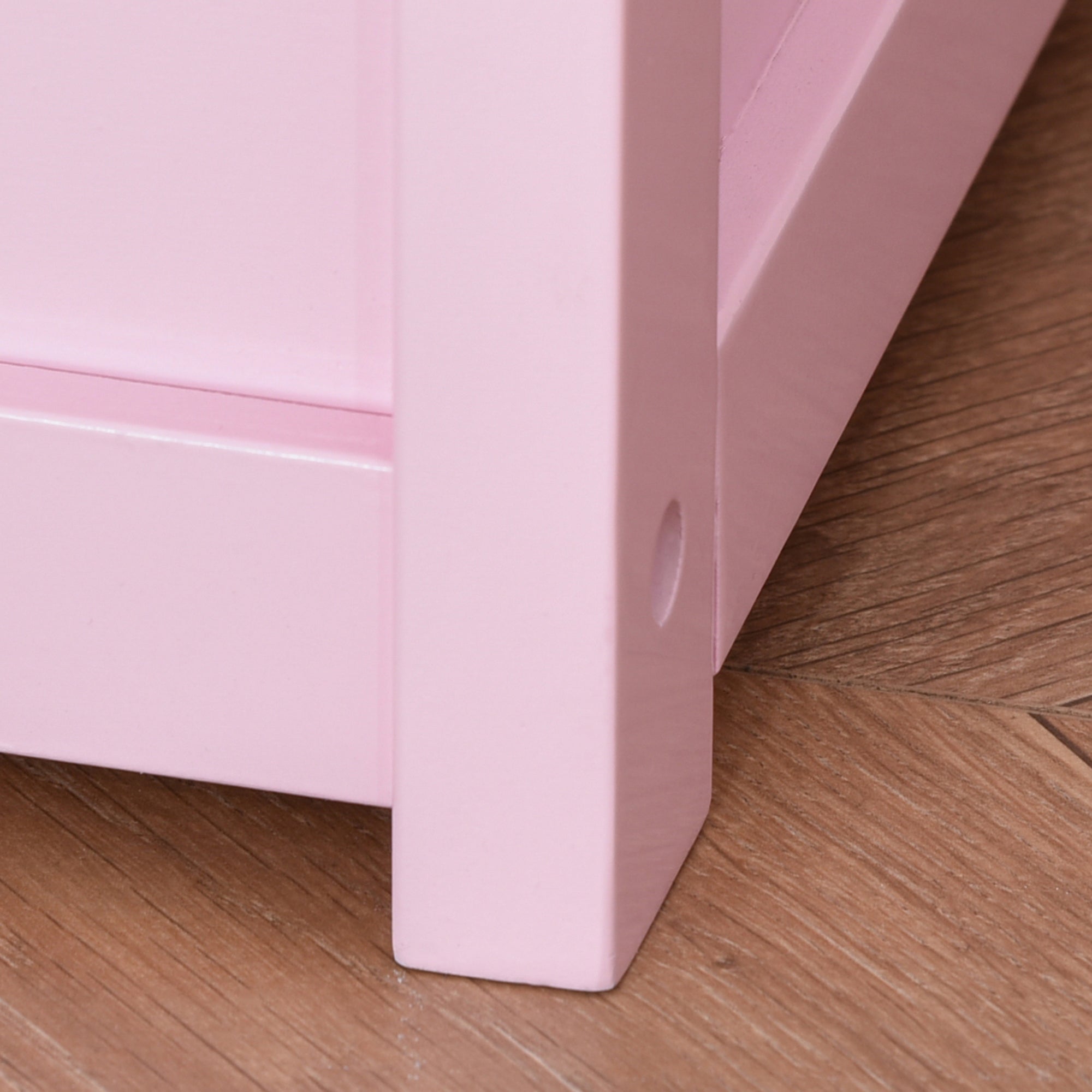 Pink wooden leg with circular hole on the homcom 2 in 1 kids storage bench and toy box organizer