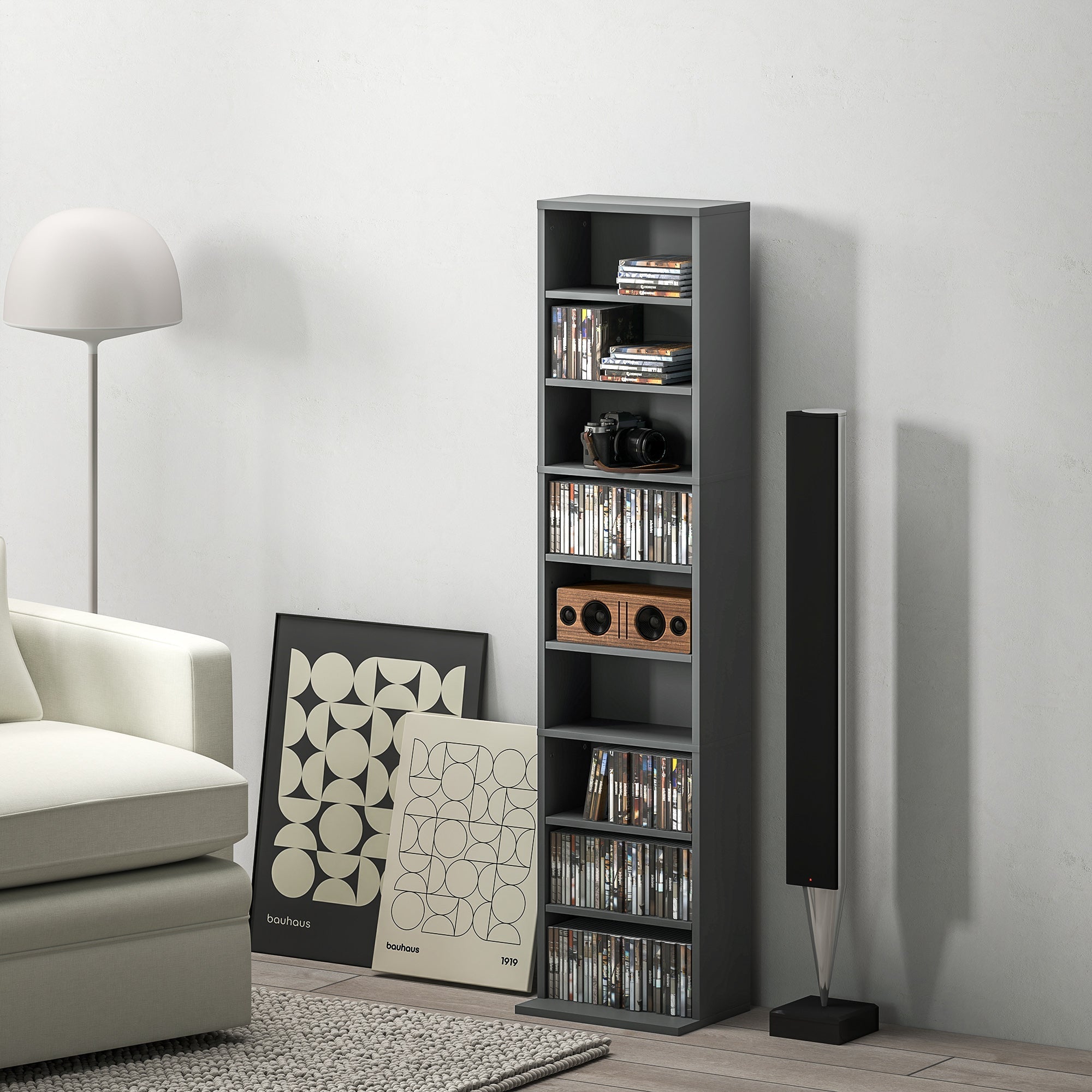 Gray HOMCOM 260 narrow storage unit made of particle board with melamine coating holding cds books and a vintage camera