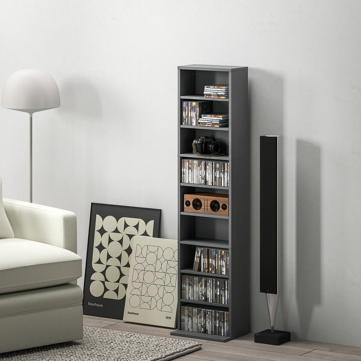 Gray HOMCOM 260 narrow storage unit made of particle board with melamine coating holding cds books and a vintage camera