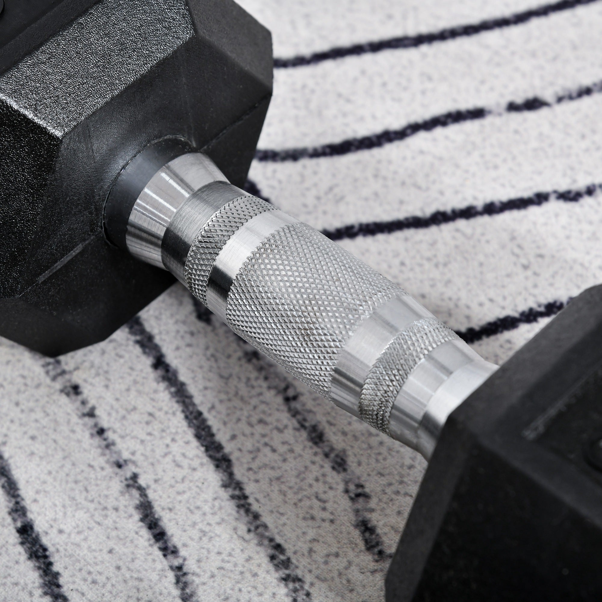 Black hexagonal rubber dumbbell with textured silver metal handle for home gym fitness by HOMCOM