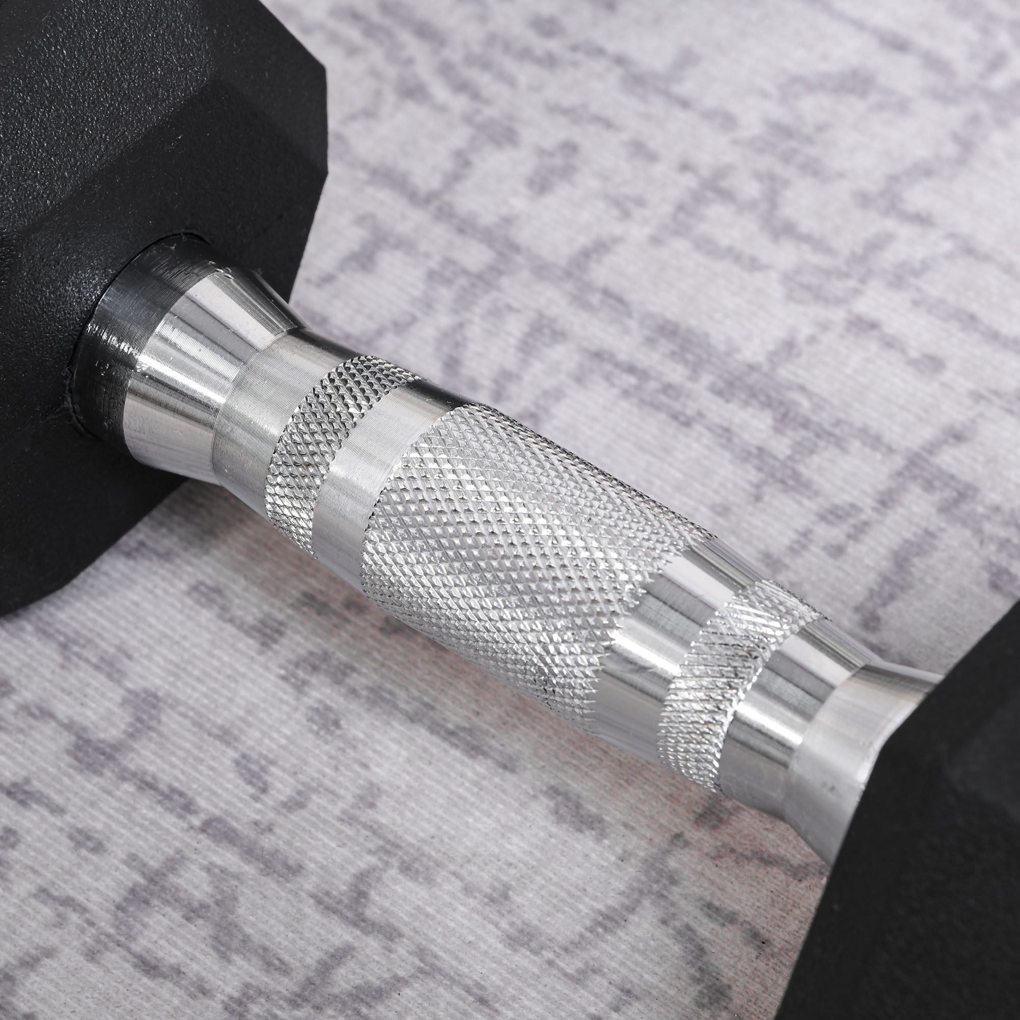 Black rubber dumbbell with knurl indents on textured silver handle in small size for home gym fitness workouts