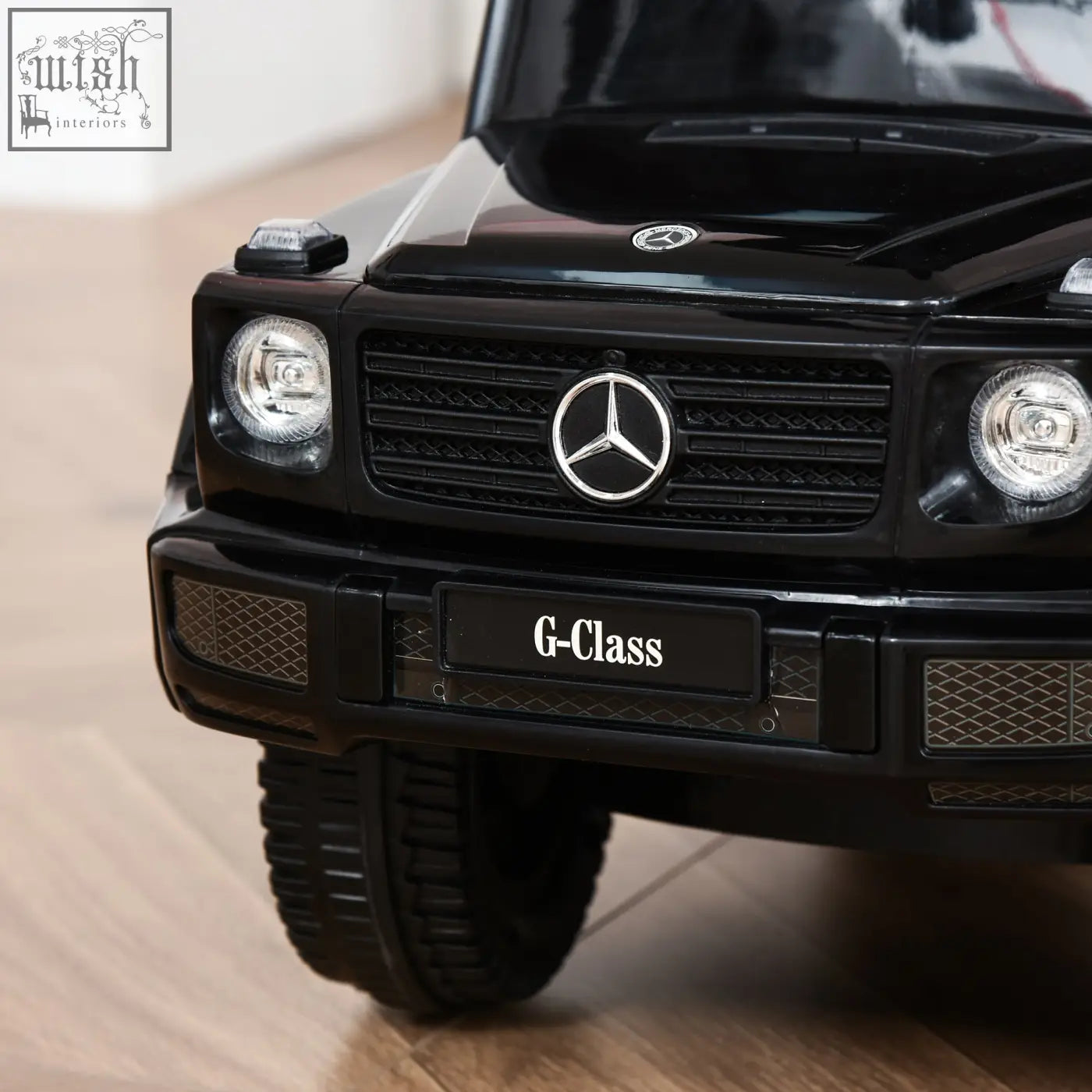 Black Mercedes-Benz g-class sliding car toy with chrome accents and moving steering wheel for toddlers to push along