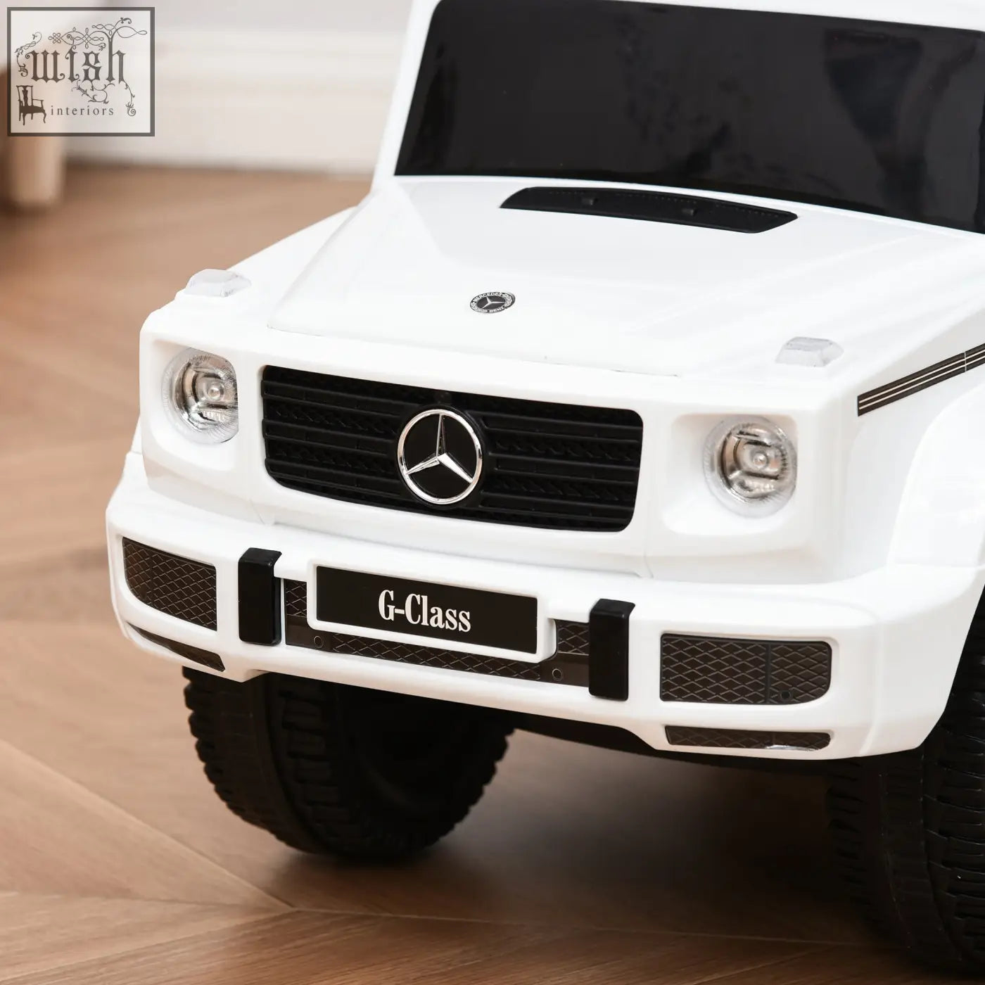 White kids mercedes benz g-class sliding car with moving steering wheel push along toy with black accents and chrome detailing