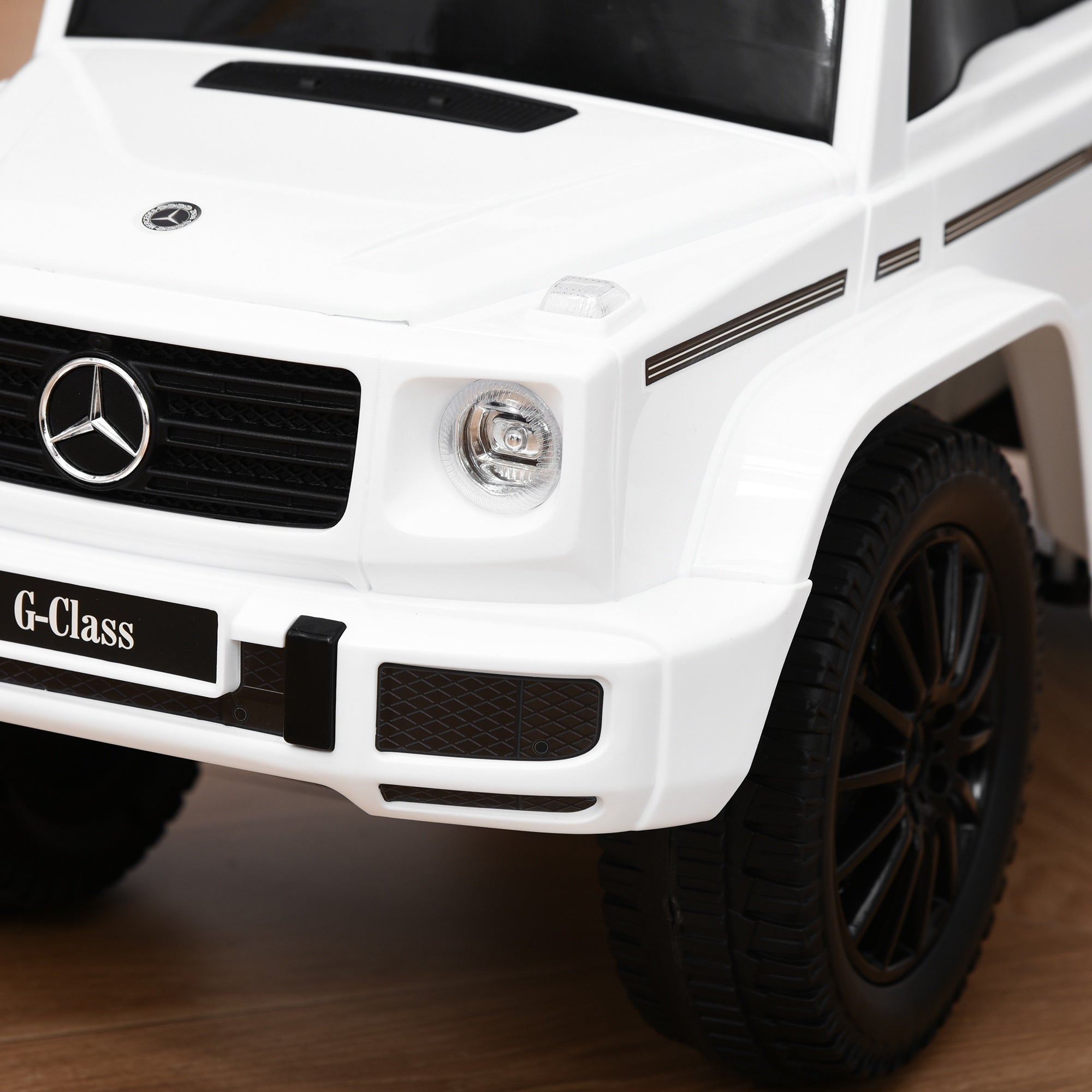 White mercedes-benz g-class electric ride-on toy car with foot-to-floor design steering wheel and under-seat storage