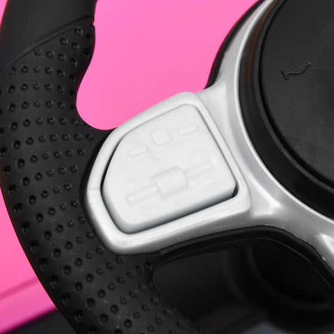 Black and silver steering wheel with textured grip and buttons on pink homcom foot-to-floor ride on car with under-seat storage