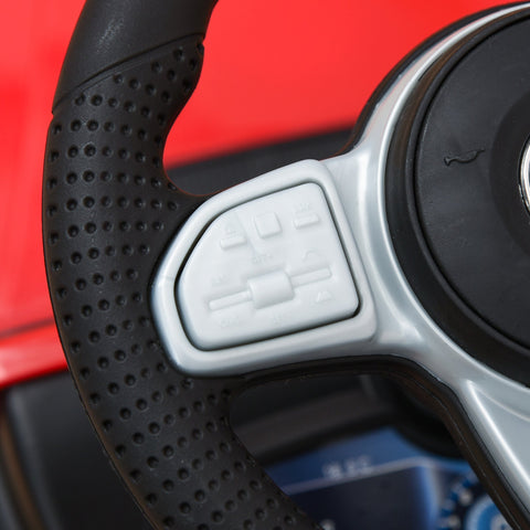 Black perforated grip steering wheel with silver accents and buttons on red homcom 3 in 1 kids ride on car with foot-to-floor design