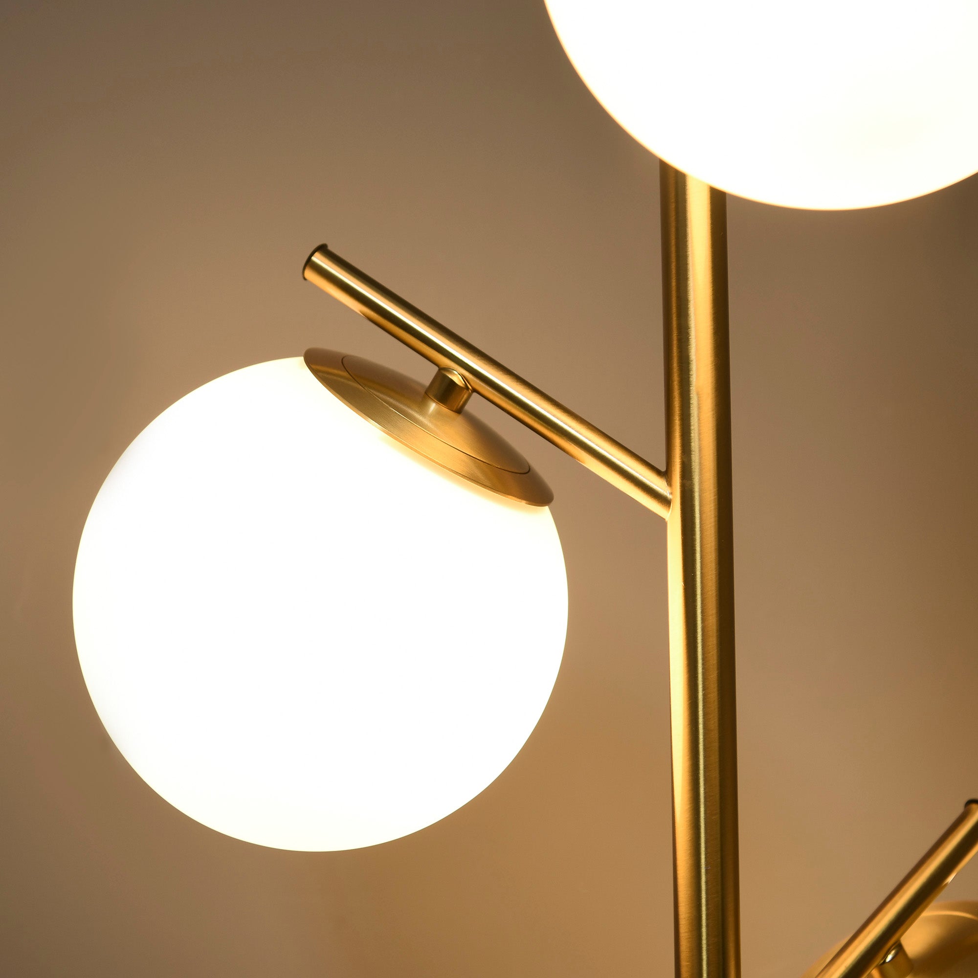 Modern gold finished floor lamp with two glowing white glass globe shades featuring 3000k 4000k 6000k colors and foot switch