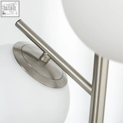 Modern silver floor lamp with brushed steel base, two white glass globe shades, e27 base and foot switch included