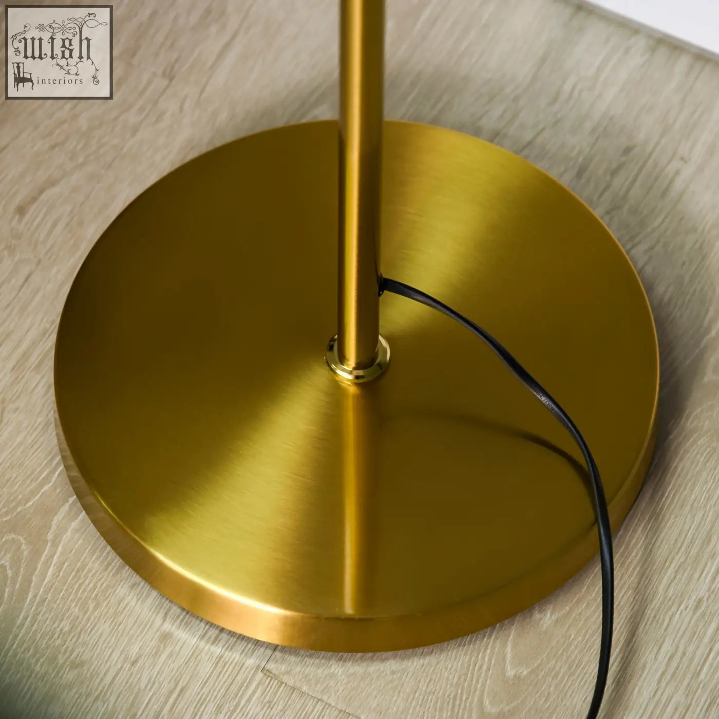 Gold tone metal floor lamp base with sleek circular design and e27 base featuring a convenient foot switch
