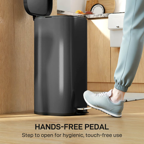 Black cylindrical kitchen bin with metal design and soft-close lid featuring a pedal for hands-free use