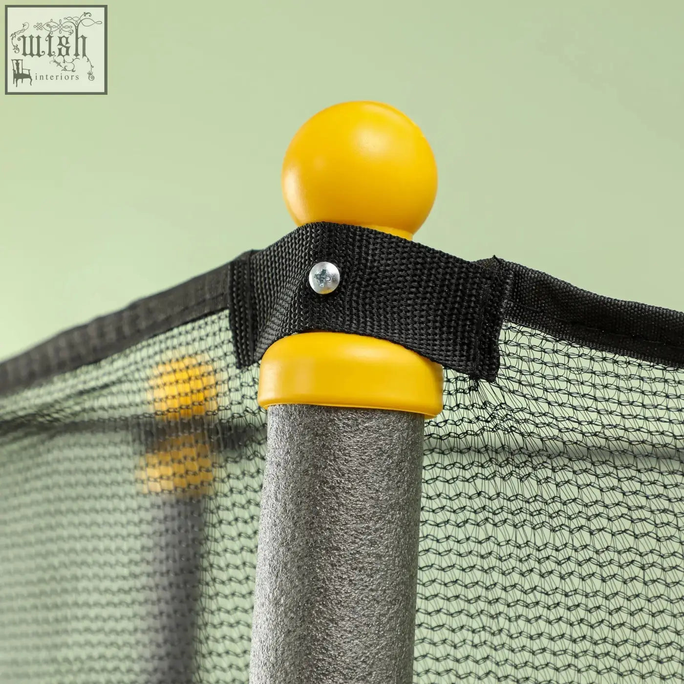 Yellow plastic ball finial on gray metal pole of black homcom kids trampoline with safety enclosure for indoor outdoor use