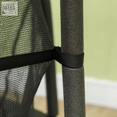 Black mesh netting with black fabric strap secured around a gray pole on homcom kids trampoline safety enclosure