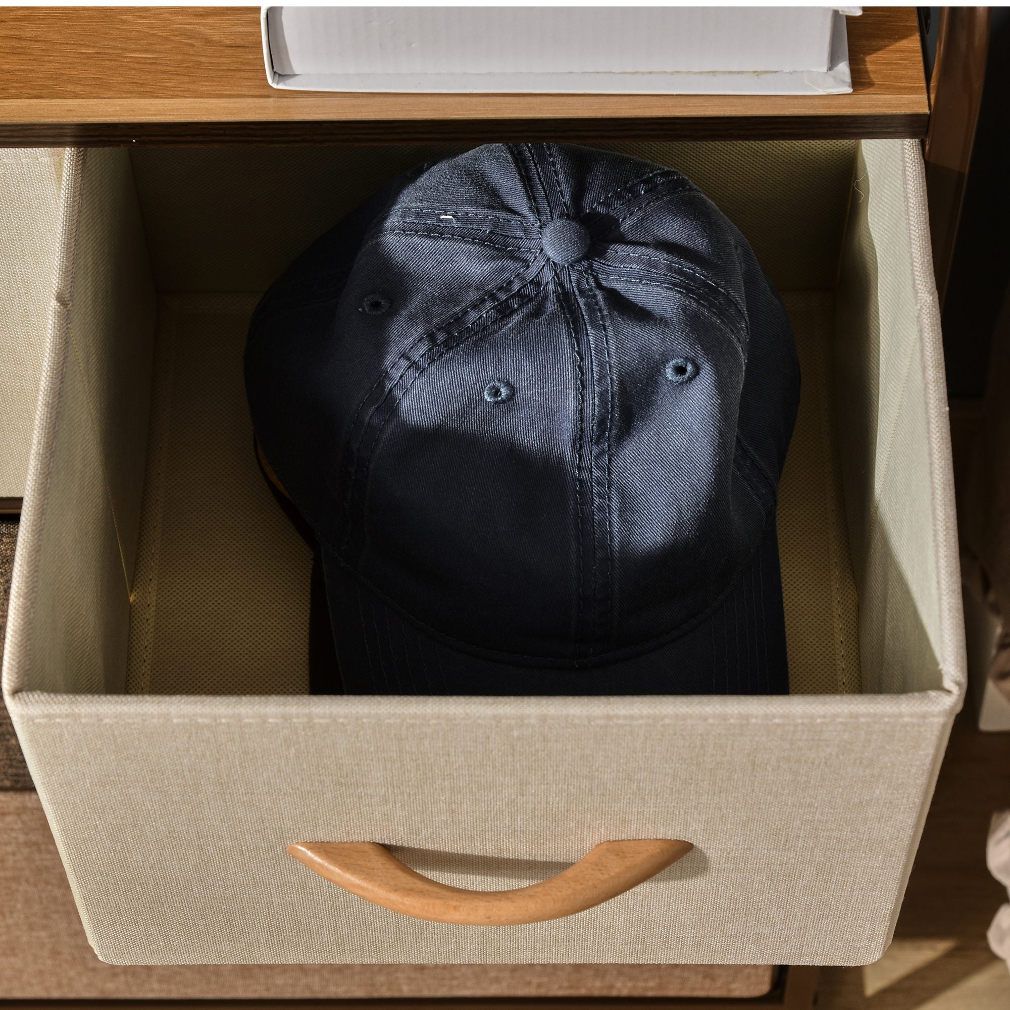 Dark denim baseball cap with stitched crown and button top paired with homcom 4-drawer dresser with two large and two small drawers
