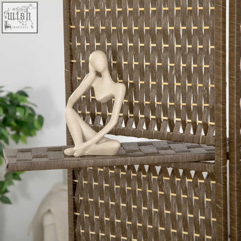 Beige abstract resin figurine of seated woman with hand to face displayed next to homcom 180l x 45w wooden frame privacy screen