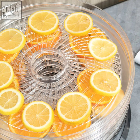 Homcom five tray food dehydrator with clear plastic trays and air circulation filled with sliced lemons and oranges