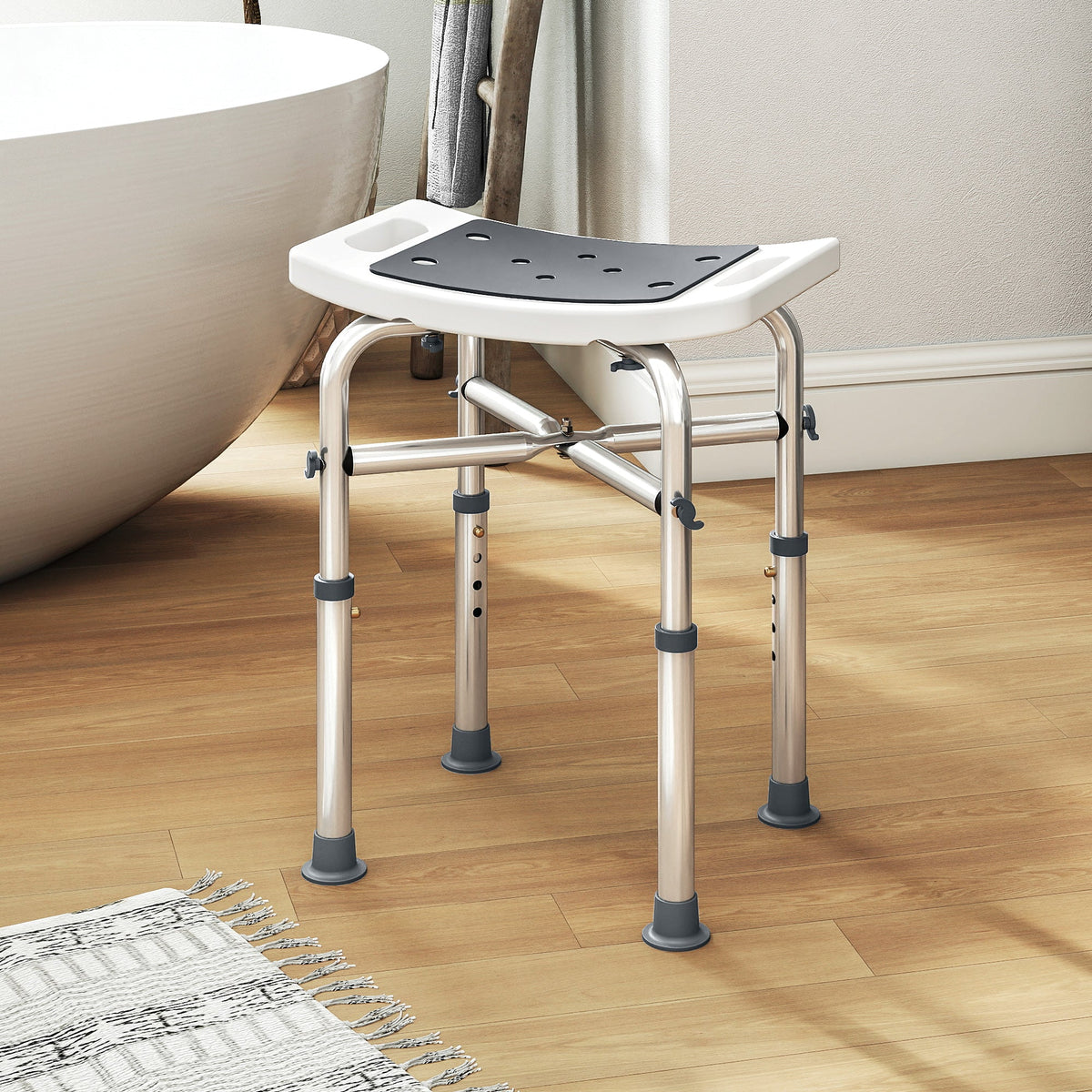 Adjustable height homcom shower chair with white plastic seat, black perforated pad, and grey aluminium frame legs