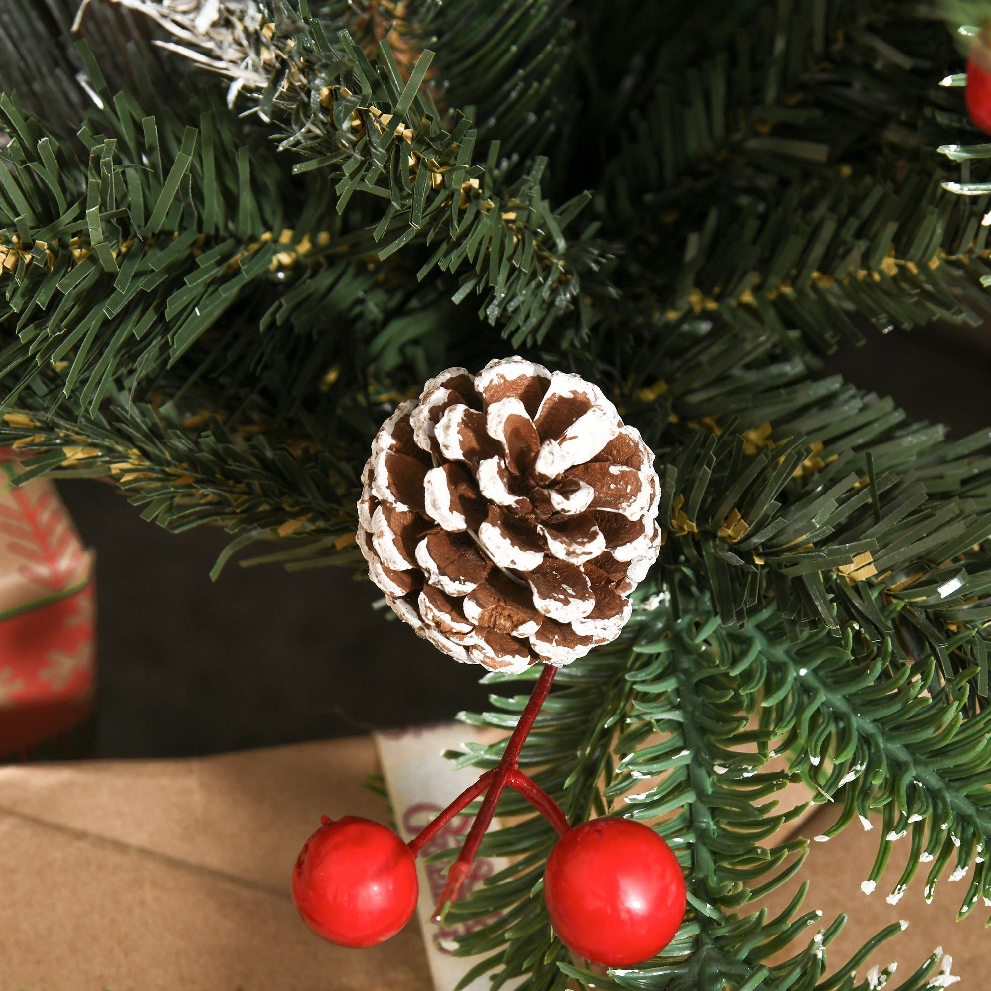 A 4ft homcom christmas tree with white pinecones and red berries featuring a decorative painted pinecone branch