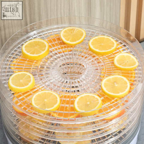 Clear plastic homcom food dehydrator with five stacking trays and adjustable temperature holding sliced lemons and oranges