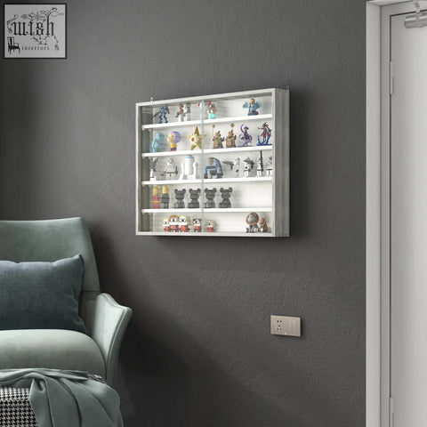 White wall-mounted display cabinet with glass doors and grey wood grain particle board showcasing colorful figurines