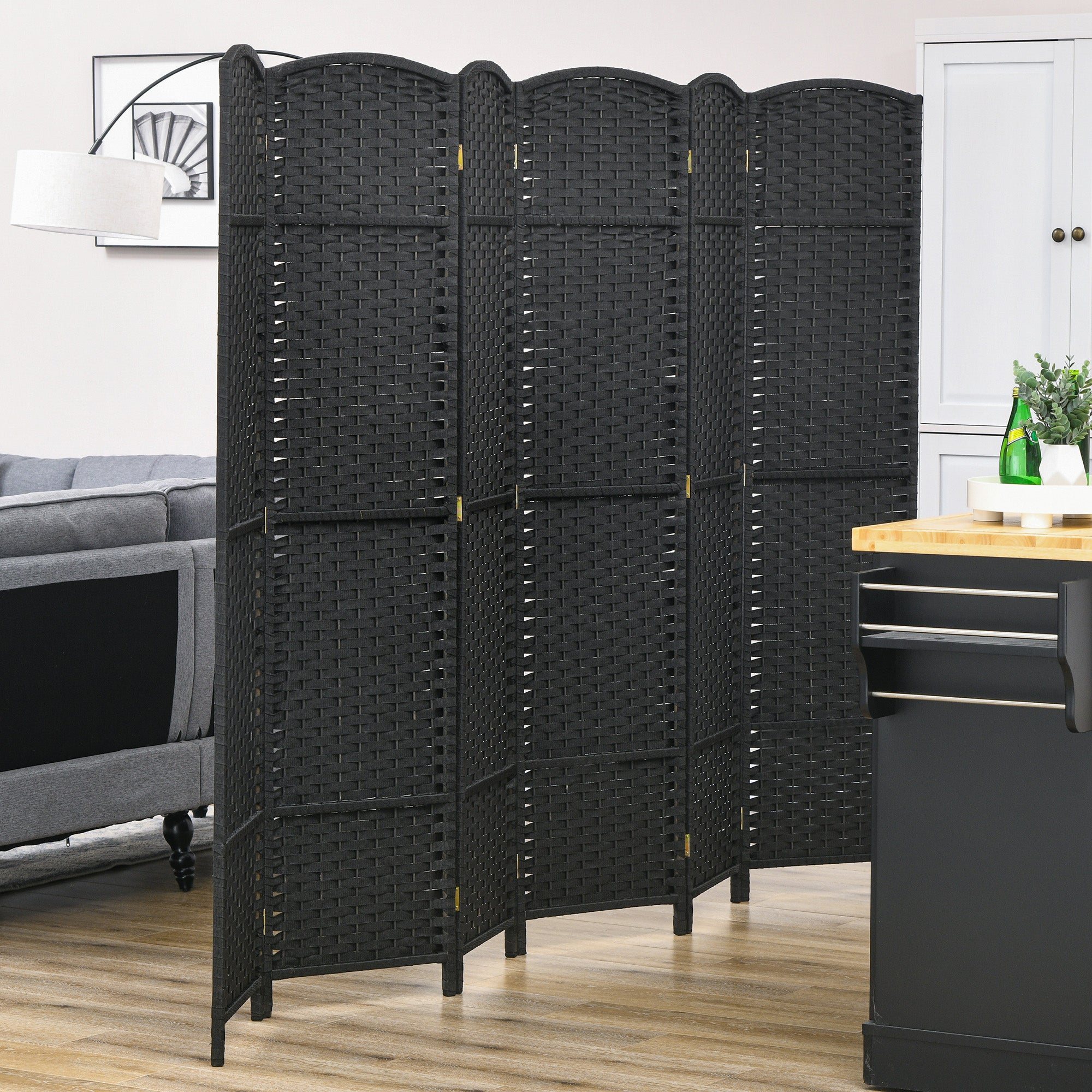 Black woven wicker folding room divider with arched top panels and gold hinges for living room or office privacy