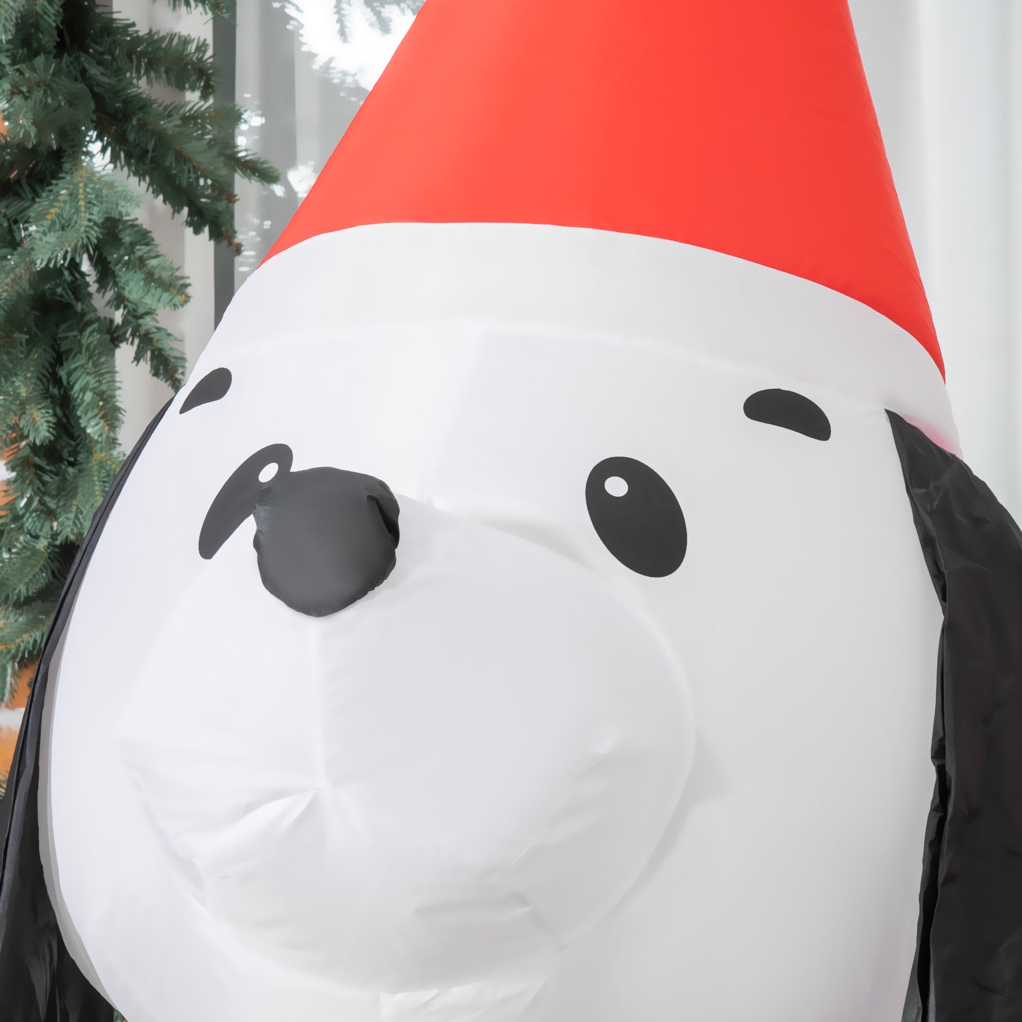 Inflatable white and black christmas puppy dog wearing red santa hat made of resistant polyester cloth for indoor outdoor use