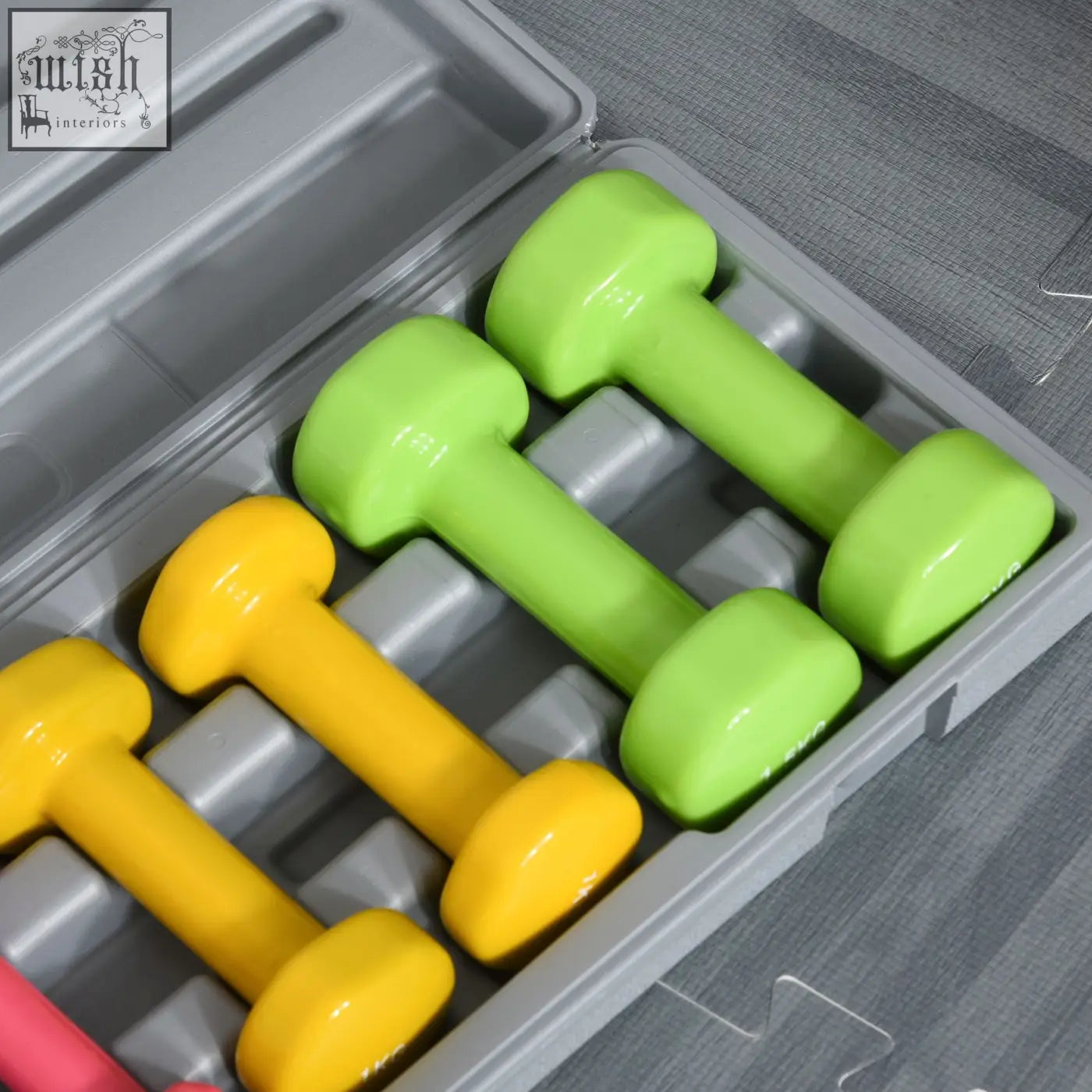 Homcom dumbbell set with three pairs of bright lime green and yellow plastic weights in a gray storage case