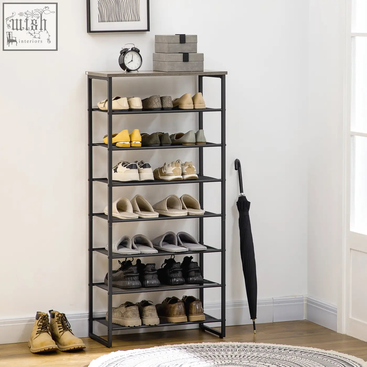 Black metal shoe rack with seven-tier narrow design and anti-tipping straps included holding shoes and umbrella nearby