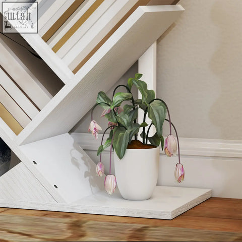 White ceramic pot with green leaves and pink flowers on a white homcom 9-tier tree bookshelf with steel frame and robust particle board