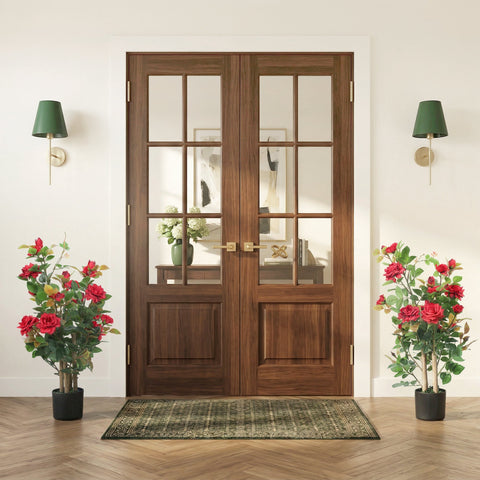 Dark wood double french doors with gold hardware beside a red artificial rose tree set with 344 silk leaves