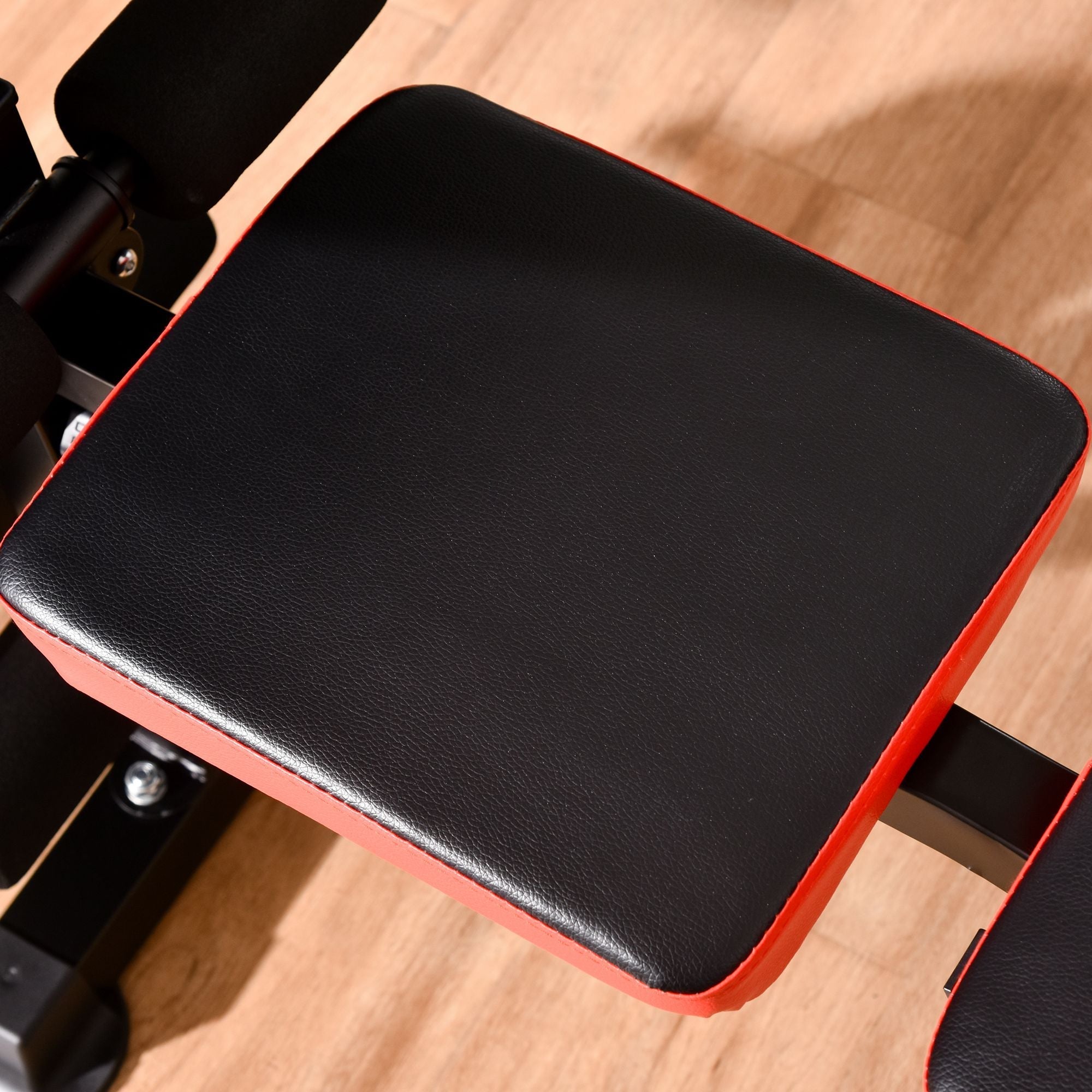Black and red padded seat pad with textured synthetic leather on homcom multifunctional weight bench unit