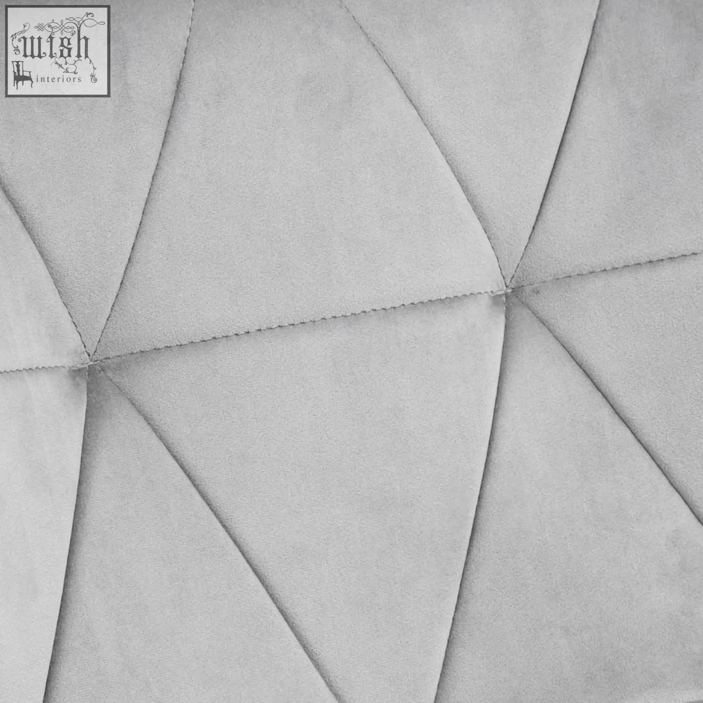 Gray suede headboard with geometric triangular tufted design featuring velvet-feel upholstery and metal frame details