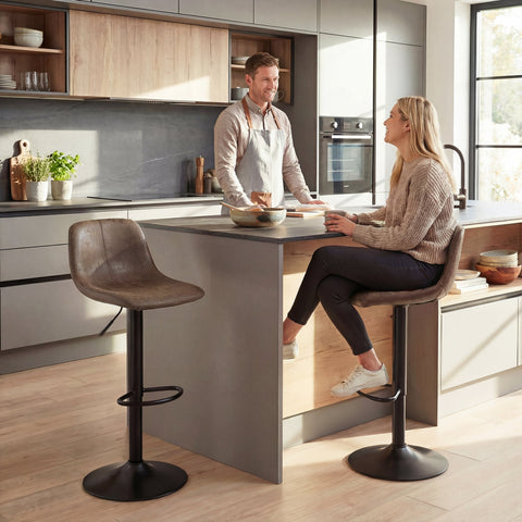 Brown leather bar stools with black carbon steel bases perfect for kitchen island seating and dining room use