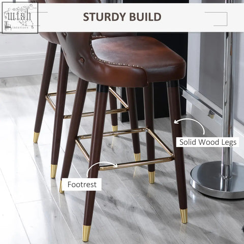 Brown leather homcom bar stools with solid wood legs and gold metal accents perfect for kitchen or counter use