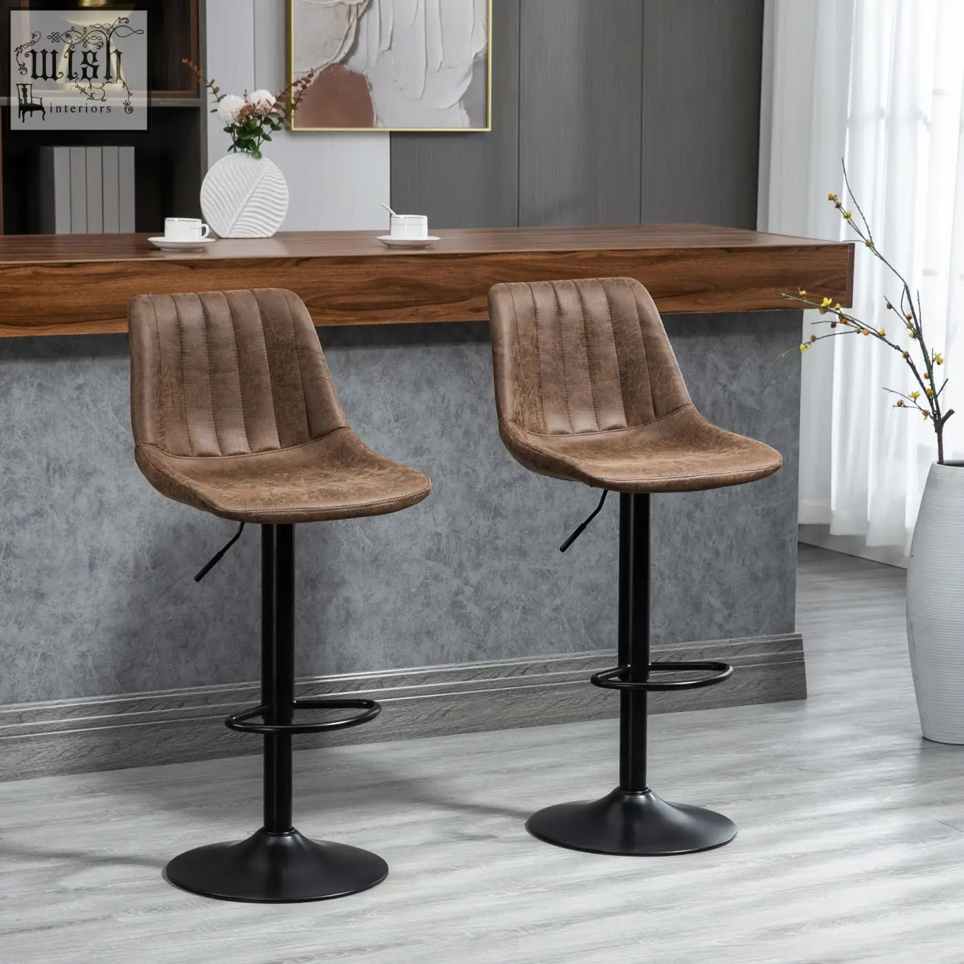 Brown tufted leather bar stools with black metal bases and adjustable footrests perfect for kitchen island use