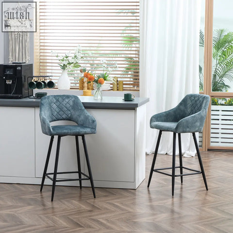 Two teal bar stools with beautiful velvet-feel upholstery and black metal legs perfect for kitchen island or dining area