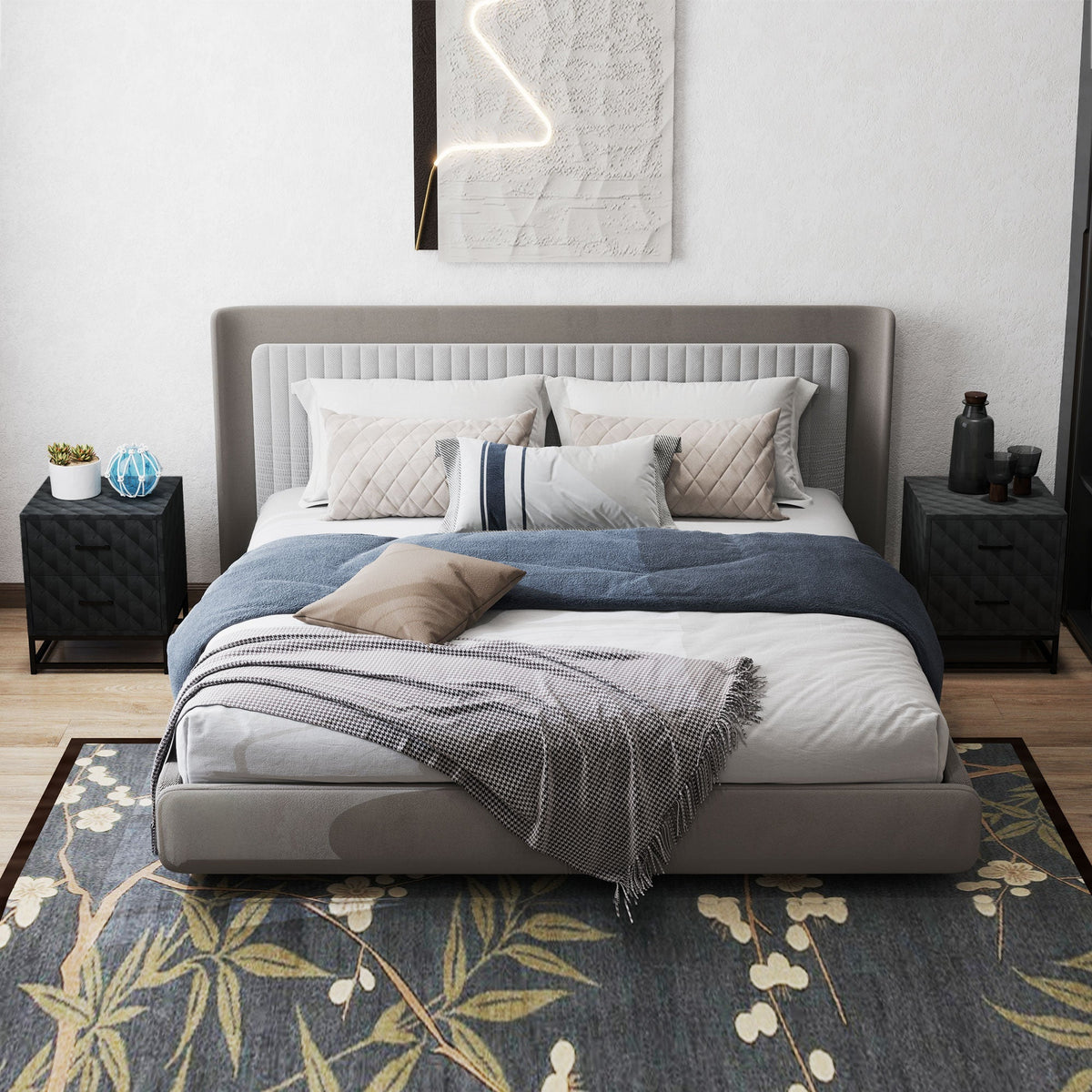 Modern gray upholstered bed with tufted headboard and white linens next to black steel frame bedside table with drawers