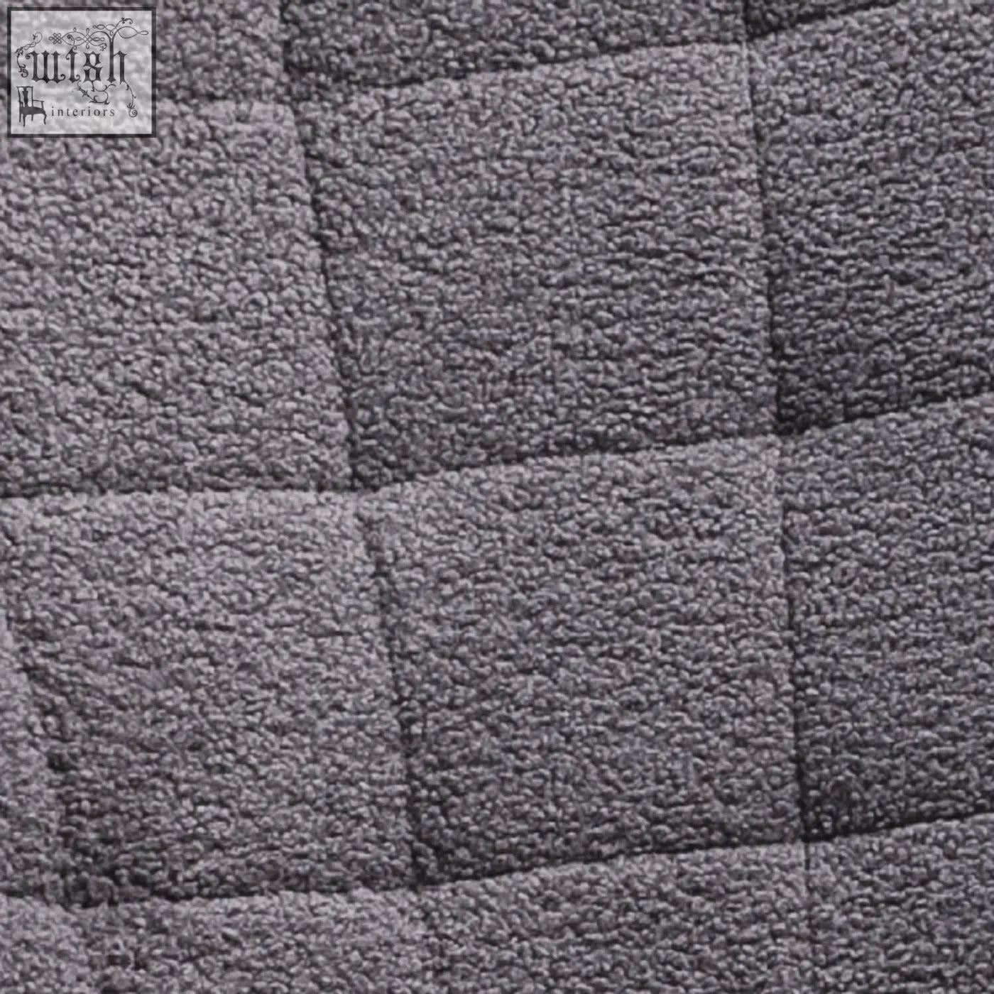 Gray quilted berber fleece rocking chair with square stitching and curved wooden base for gentle rocking in nursery
