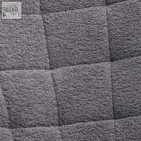 Gray quilted berber fleece rocking chair with square stitching and curved wooden base for gentle rocking in nursery