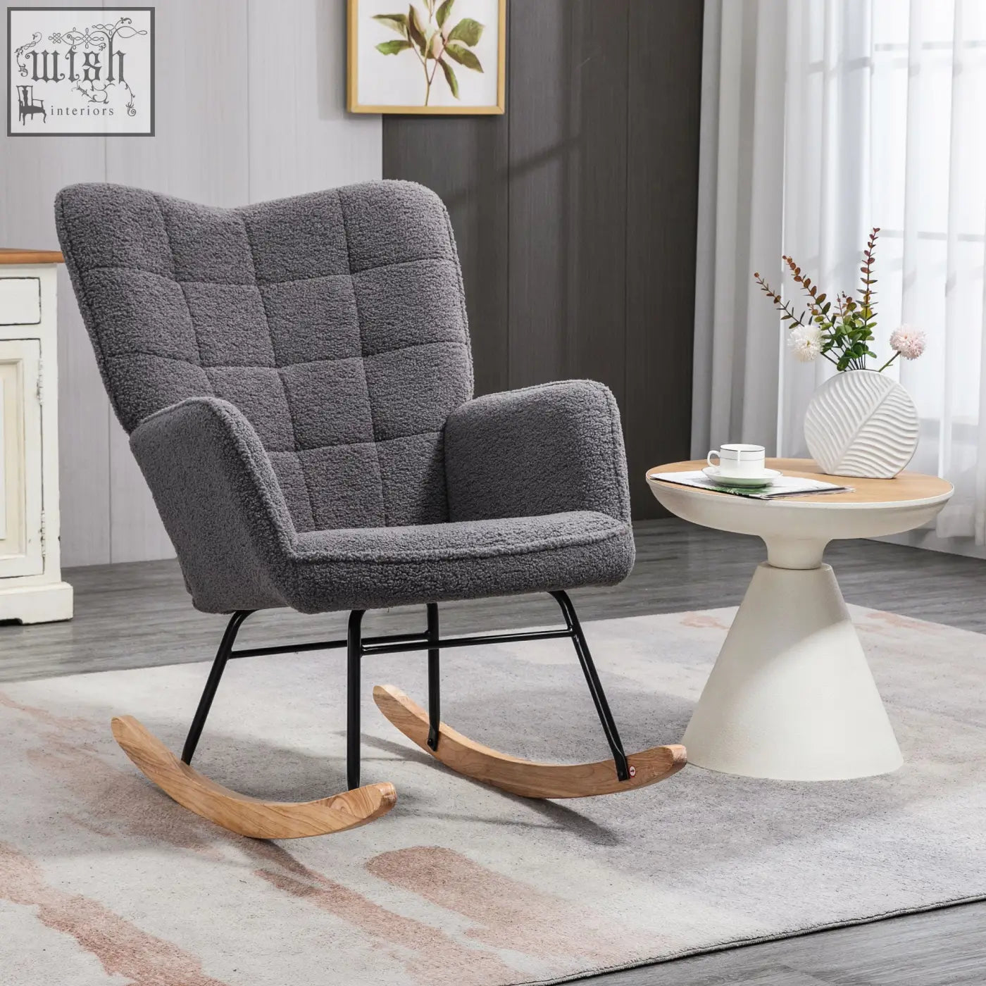 Gray tufted rocking chair with black metal frame and curved wooden base for gentle rocking in nursery or living room