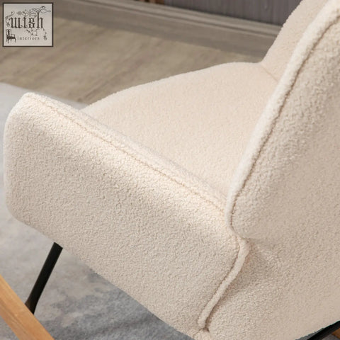 Cream-colored plush faux fur rocking chair with cozy texture and sleek black metal legs for gentle rocking