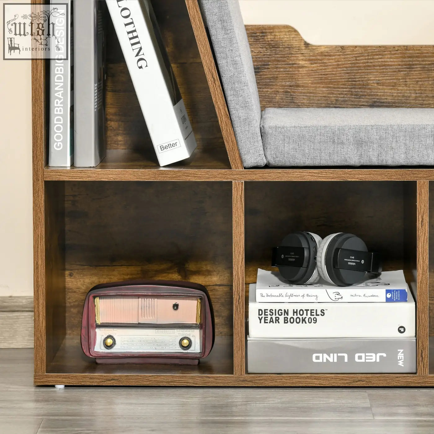 Maroon and gold vintage-style radio on sleek rustic brown particle board bookcase storage shelf with cushioned seat