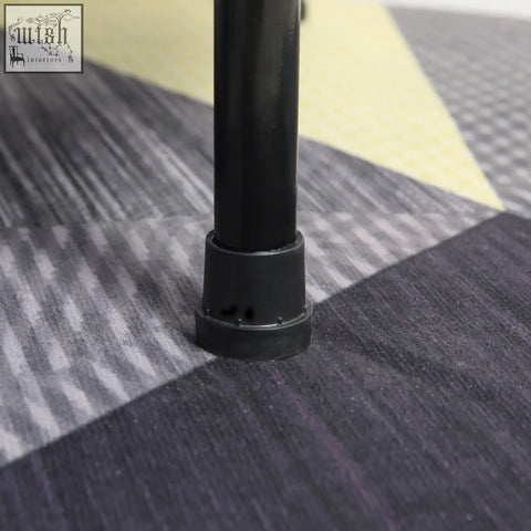 Black plastic table leg protector with rounded edges on the solid metal frame of homemcom mini fitness trampoline