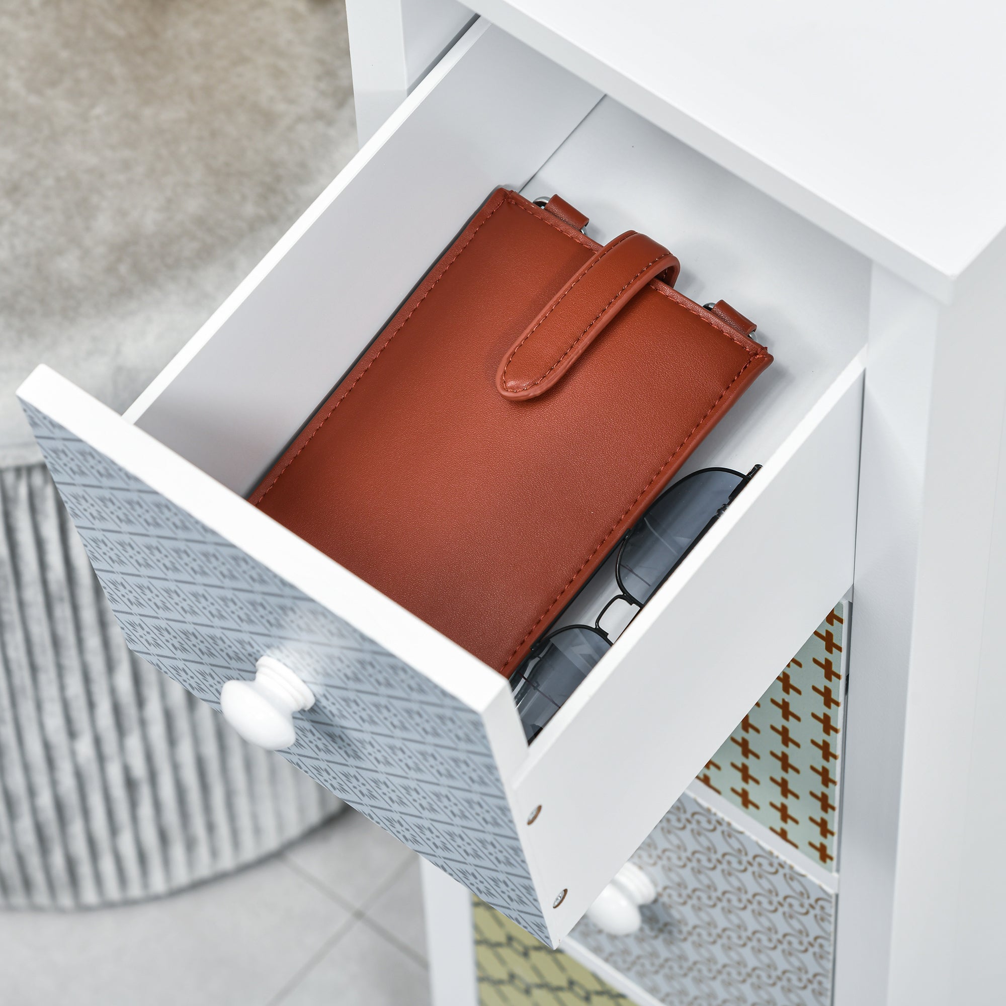 Brown leather wallet with flap closure and stitching shown with homcom chest of drawers featuring anti-tipping straps