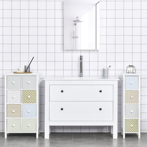 White bathroom vanity with two drawers and black knobs with matching patterned storage units and anti-tipping straps