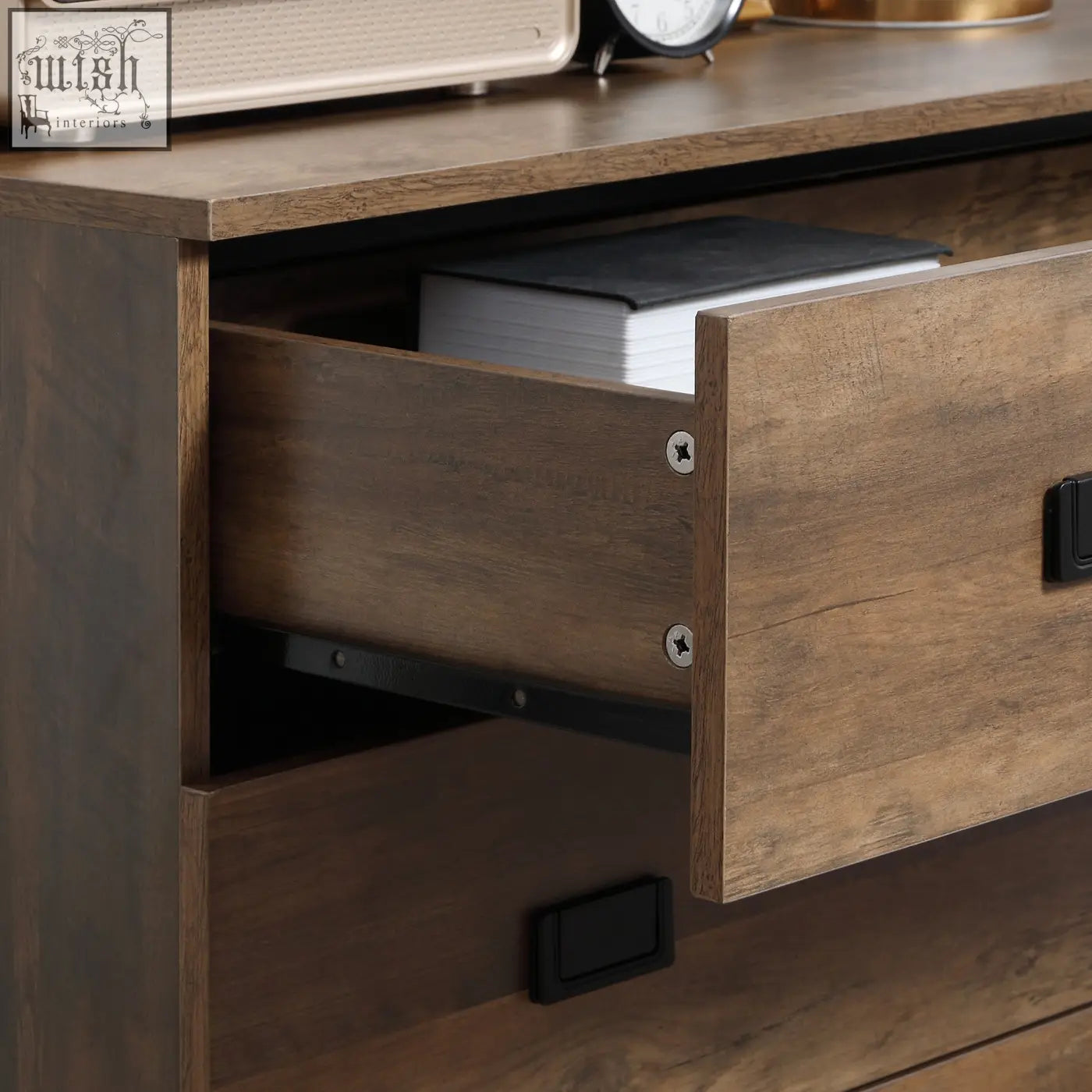 Brown particle board homcom chest of drawers with black pulls and visible book inside open drawer designed to close easily with anti-tipping straps