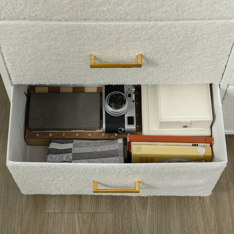 Silver and black vintage camera resting inside an open fabric drawer of a cream white HOMCOM chest with boucle fabric drawers and adjustable feet pads