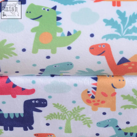 White plush flannel-feel upholstery with colorful cartoon dinosaur pattern on homcom kids sofa with wood frame